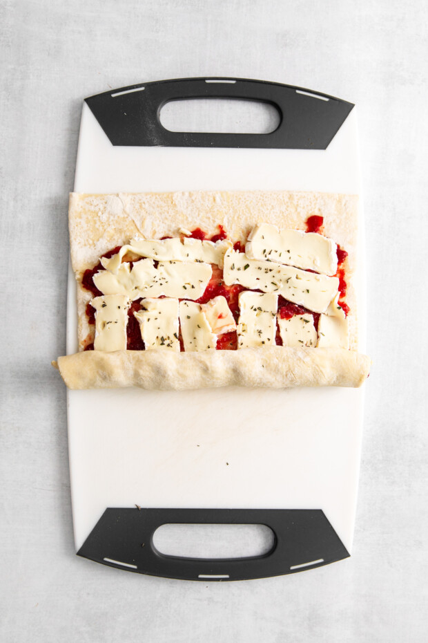 Puff pastry rolling up cranberry sauce and brie cheese. 