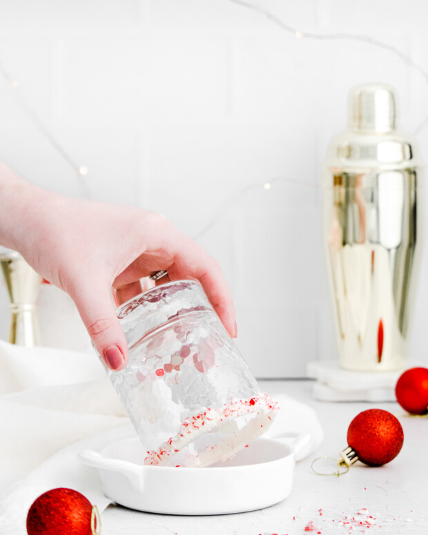 Rimming a glass with crushed candy cane. 