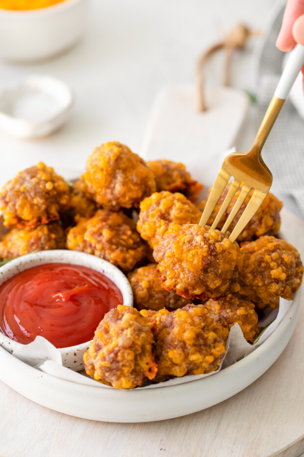 A fork picking up a Sausage Cheese Ball. 