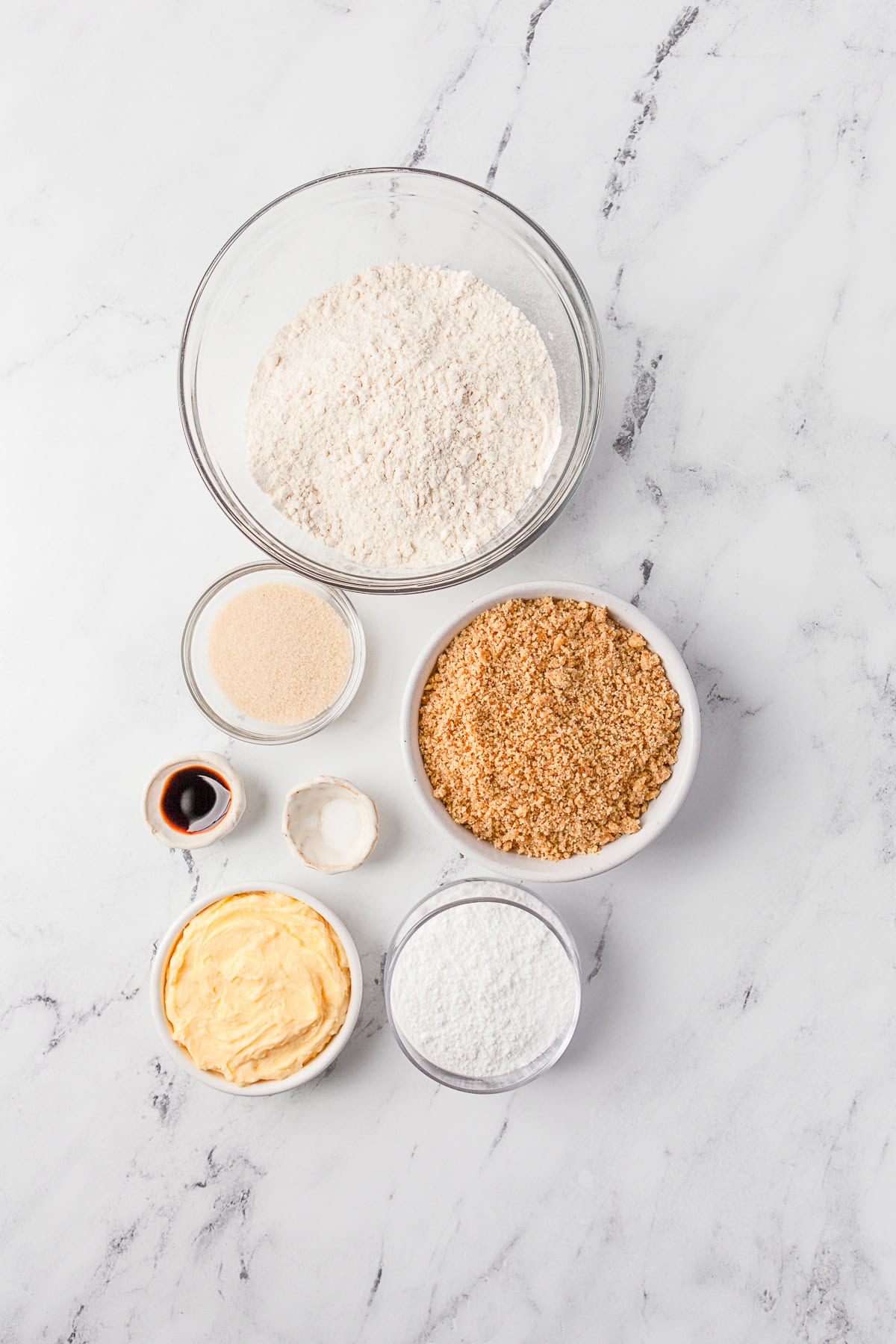 Ingredients to make Snowball Cookies sitting on a table. 