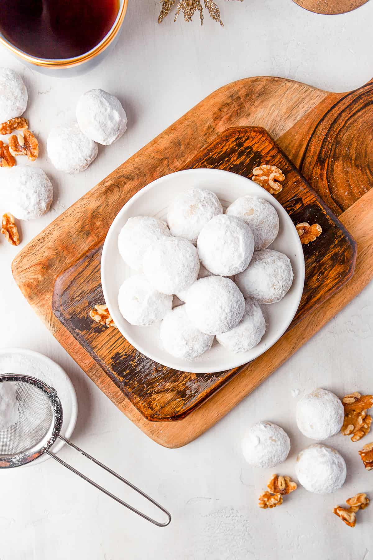 Snowball Cookies on a plate rolled in powdered sugar. 