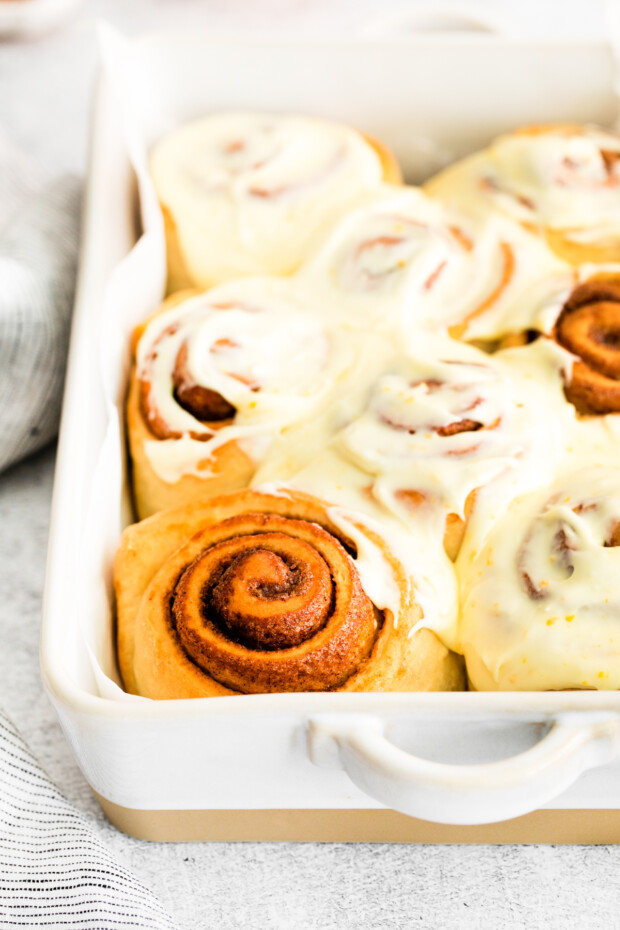 Spiced Orange Cinnamon Rolls topped with frosting.