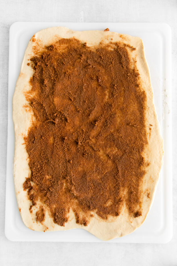 Dough spread with spiced cinnamon and orange filling.