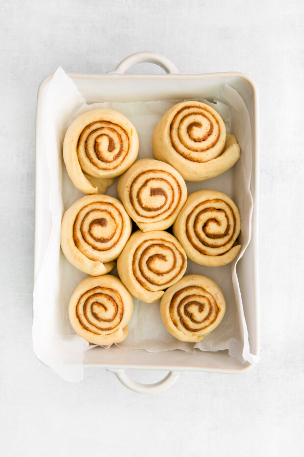 Spiced Orange Cinnamon Rolls in a dish ready to bake.