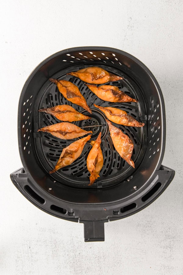Air Fryer Buffalo Chicken Wontons cooked in an air fryer basket. 