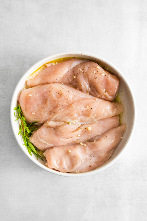 Air Fryer Lemon Chicken marinating in a bowl. 