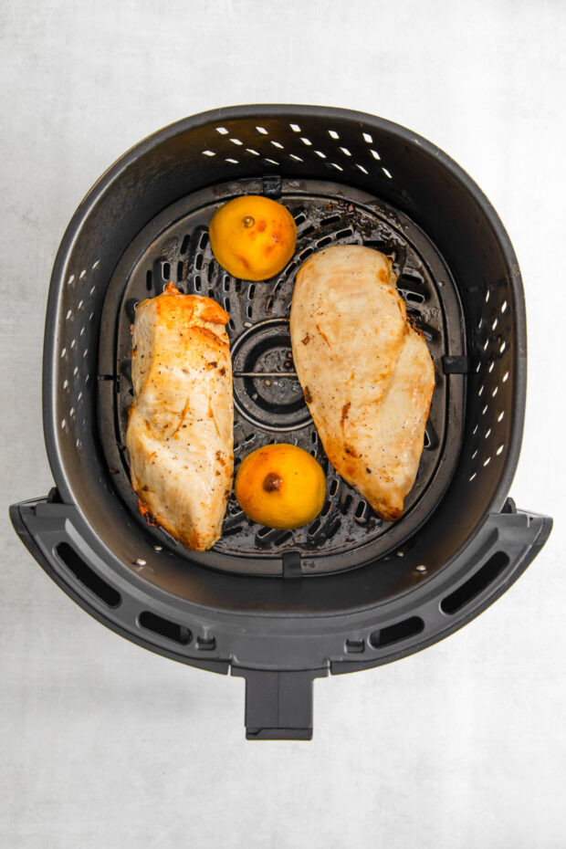 Cooked Air Fryer Lemon Chicken in the air fryer basket. 
