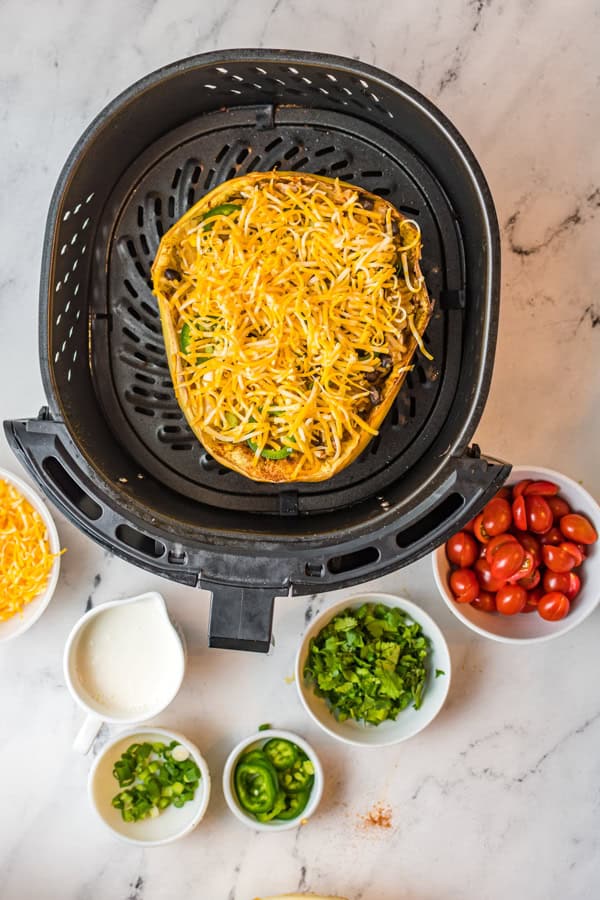 Air Fryer Southwest Spaghetti Squash in the air fryer topped with cheese. 