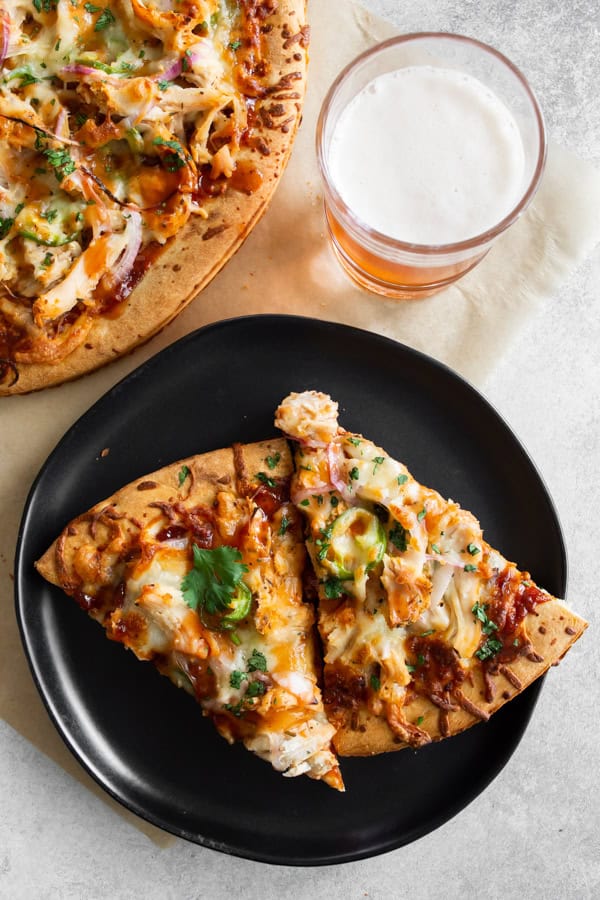 BBQ Chicken Pizza on a black plate. 