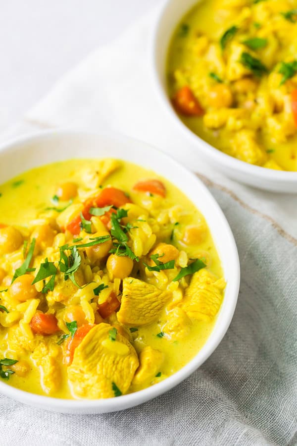 Chicken Coconut Milk Turmeric Soup topped with minced herbs. 
