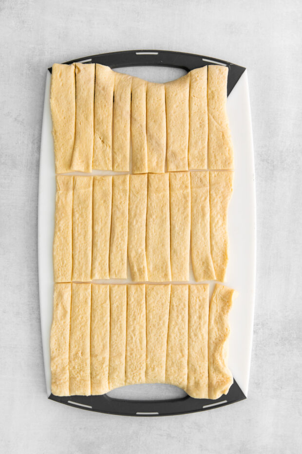 Sliced crescent dough on a cutting board.