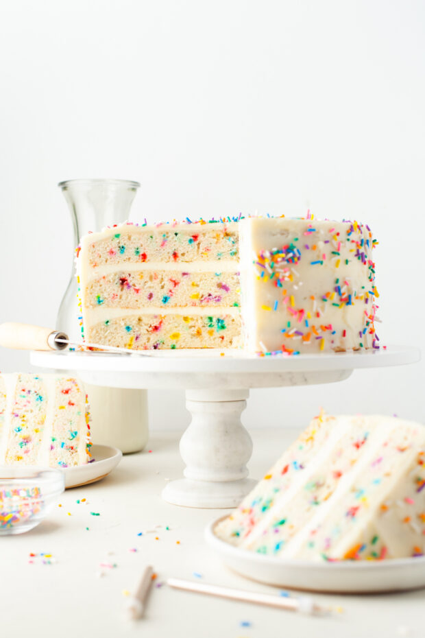 Funfetti Cake sliced on a cake stand. 
