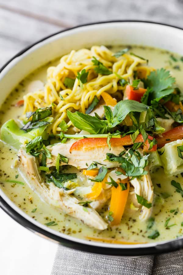 Green Curry Chicken Noodle Soup in a bowl topped with Thai basil.