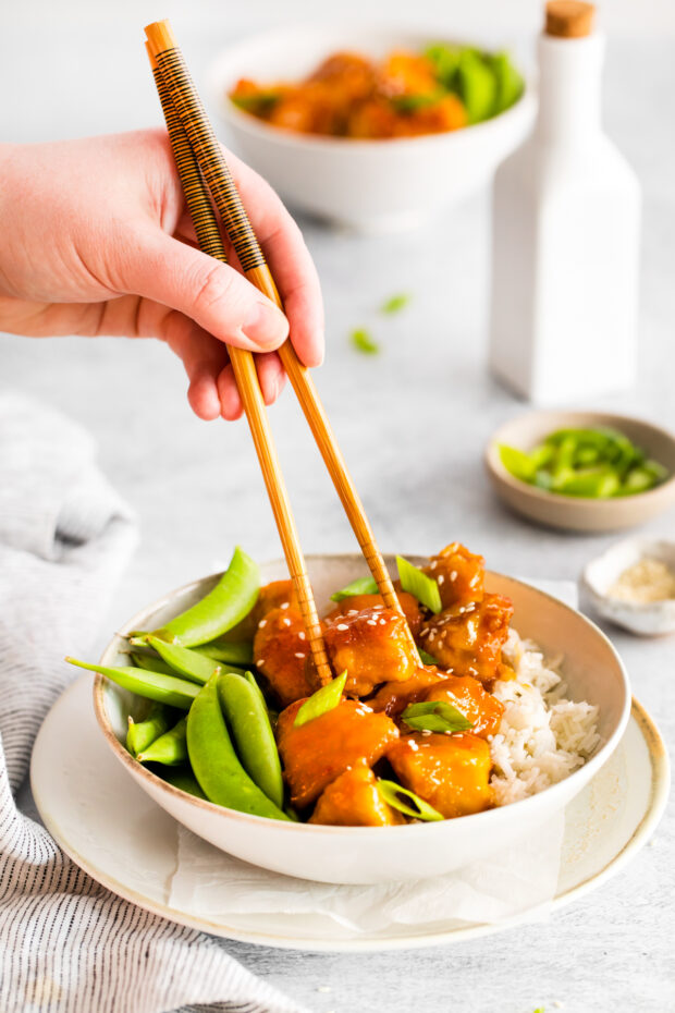 Honey Garlic Chicken Bowls served with chop sticks.