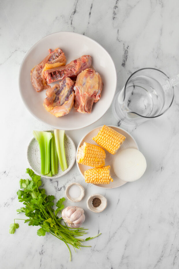Ingredients to make Instant Pot Chicken Stock sitting on at able. 