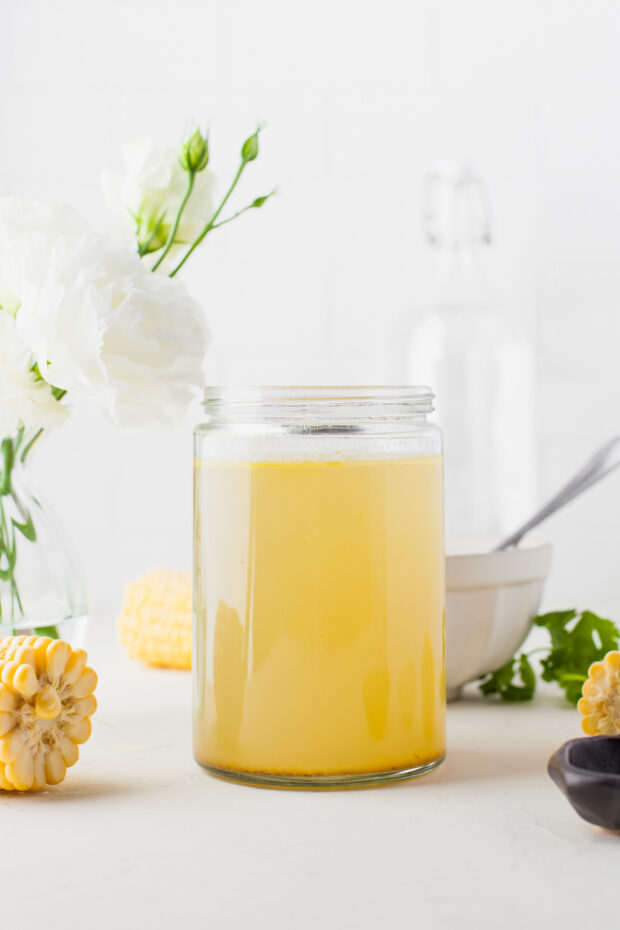 Instant Pot Chicken Stock in a glass jar cooling. 