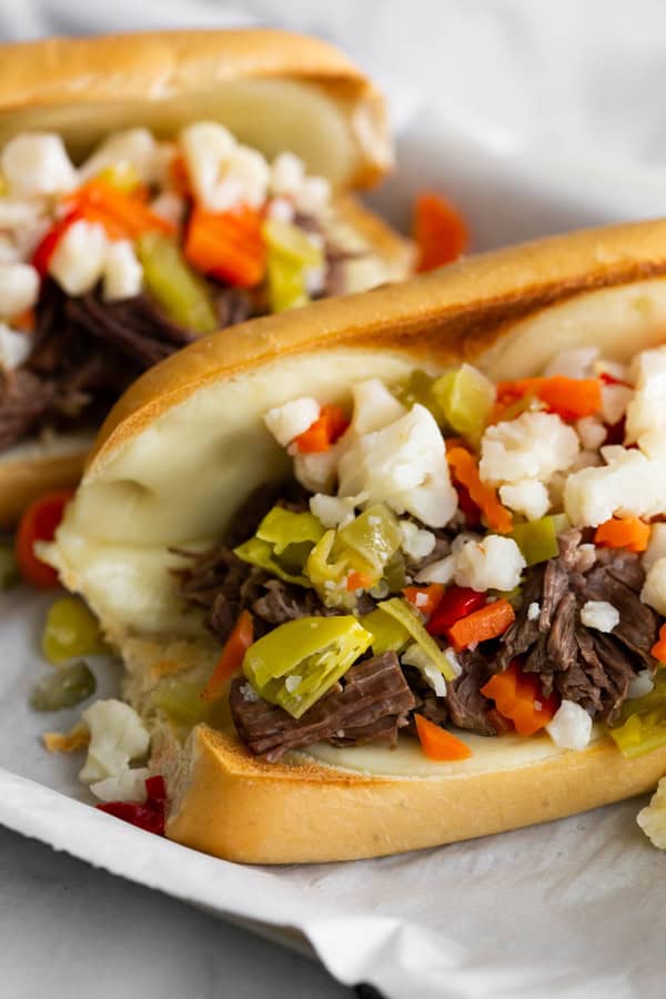 Instant Pot Italian Beef Sandwich served with pickled vegetables and cheese. 