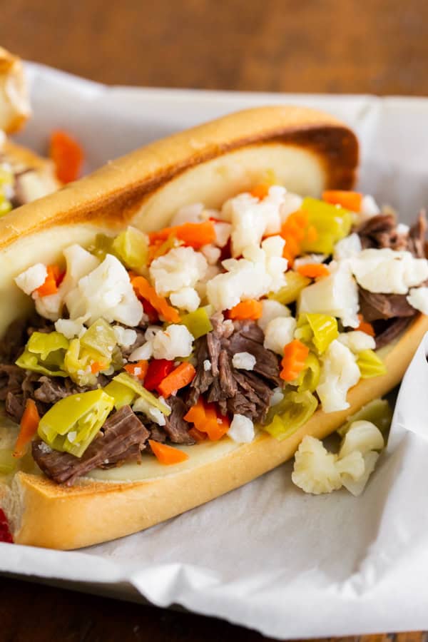 Instant Pot Italian Beef Sandwich topped with pickled vegetables. 