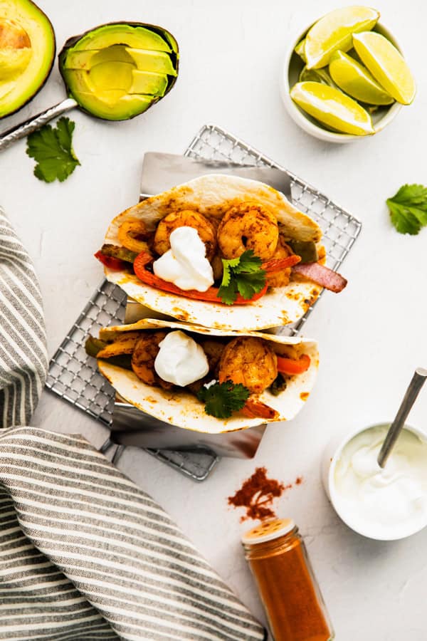 Sheet Pan Shrimp Fajitas wrapped in a tortilla.
