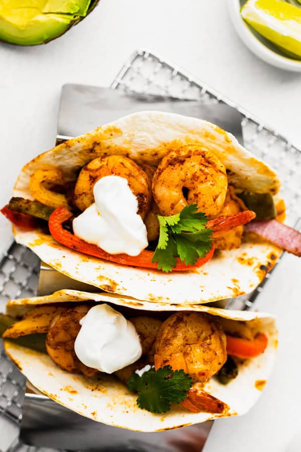 Sheet Pan Shrimp Fajitas served with sour cream and cilantro. 