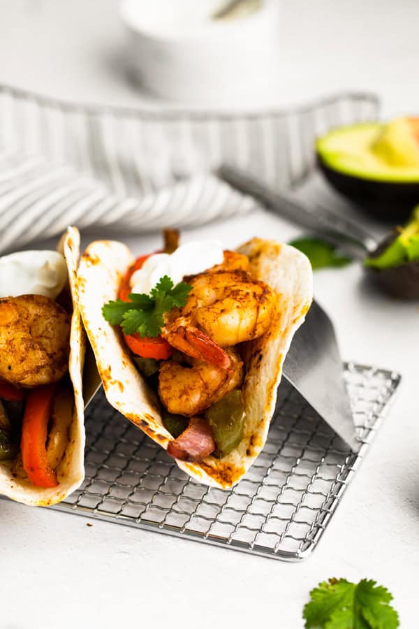 Sheet Pan Shrimp Fajitas in a tortilla. 