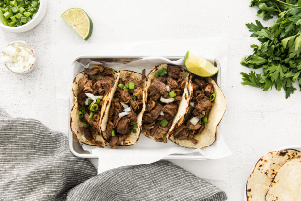 Slow Cooker Beef Barbacoa served with lime. 