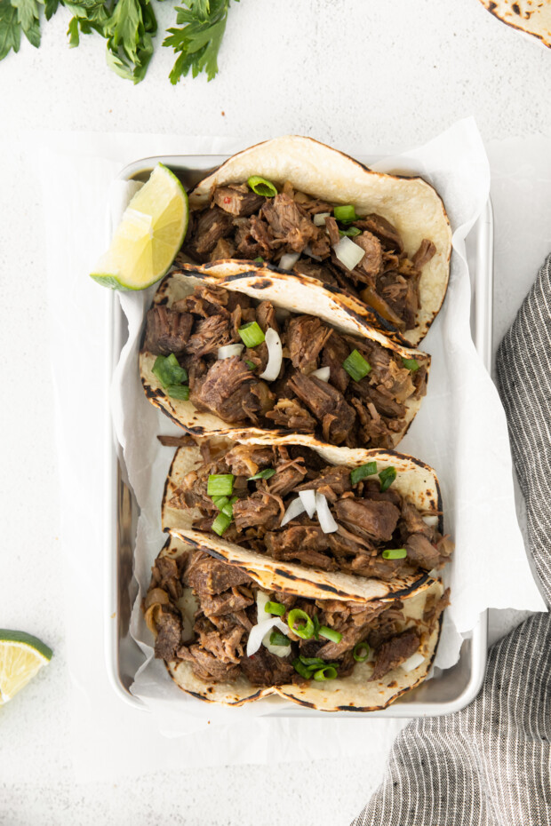 Slow Cooker Beef Barbacoa served with green onions. 
