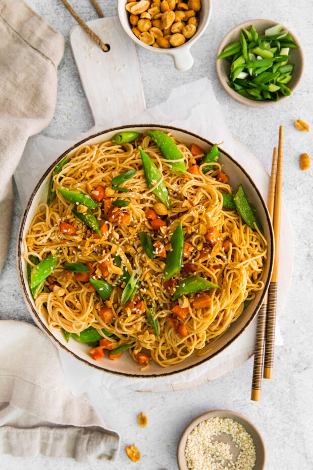 Spicy Peanut Noodles in a bowl with chop sticks.