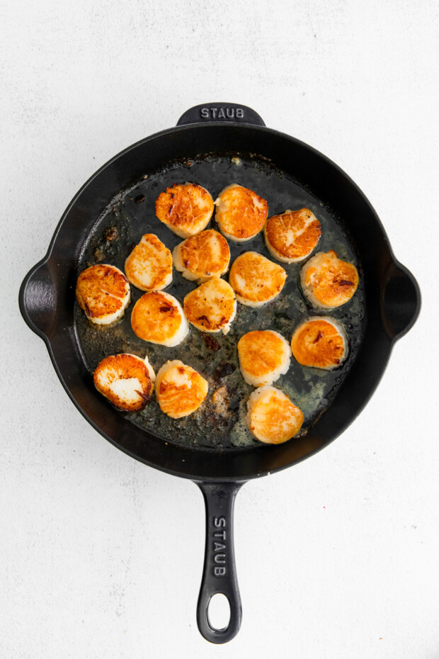 Seared Scallops in a cast iron skillet. 
