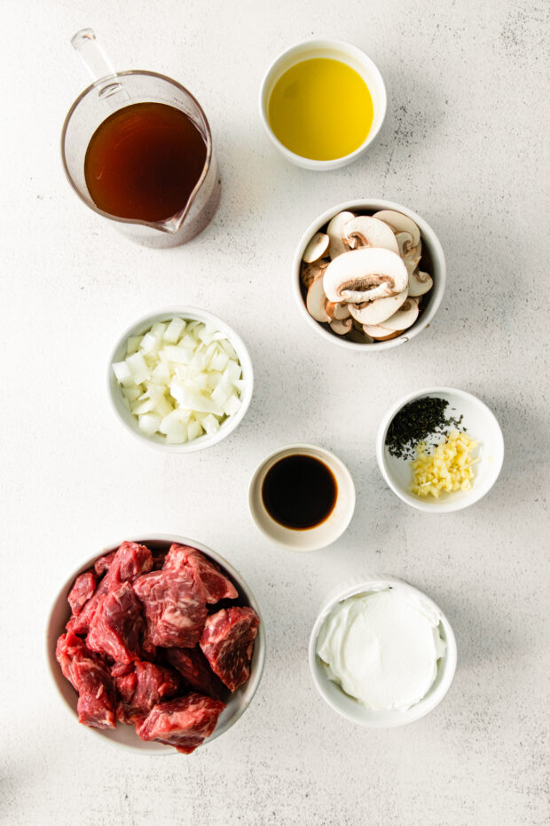 Ingredients to make Slow Cooker Beef Stroganoff on a table. 