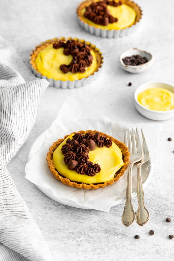 Boston Cream Pie Tarts served on a white plate.