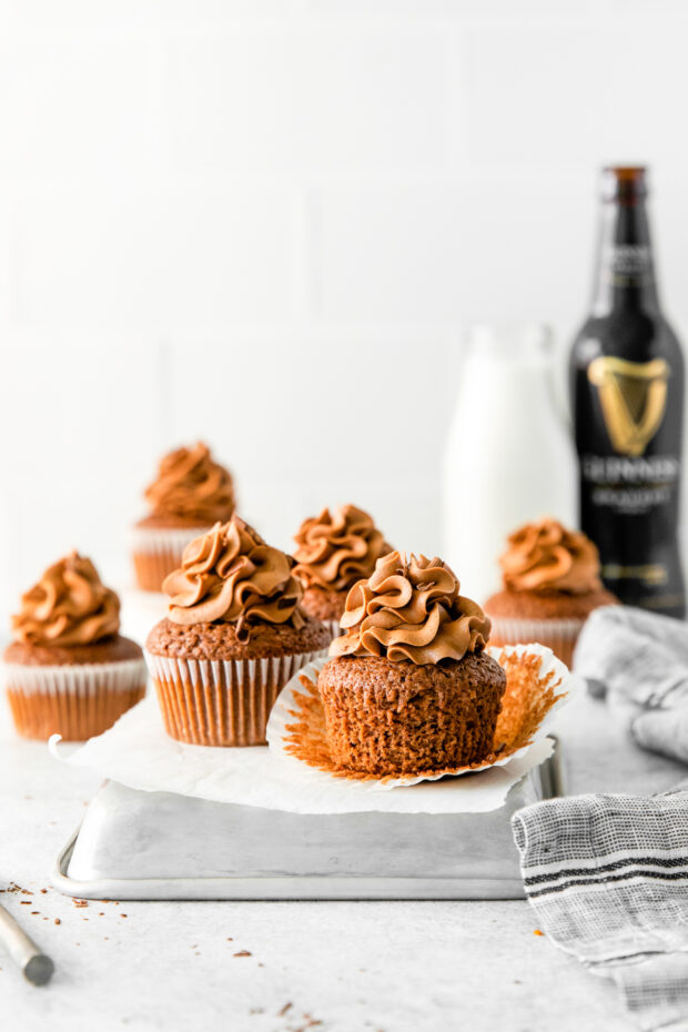 Chocolate Guinness Cupcakes on a table with frosting. 