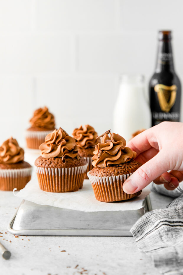 A hand grabbing a Chocolate Guinness Cupcake. 