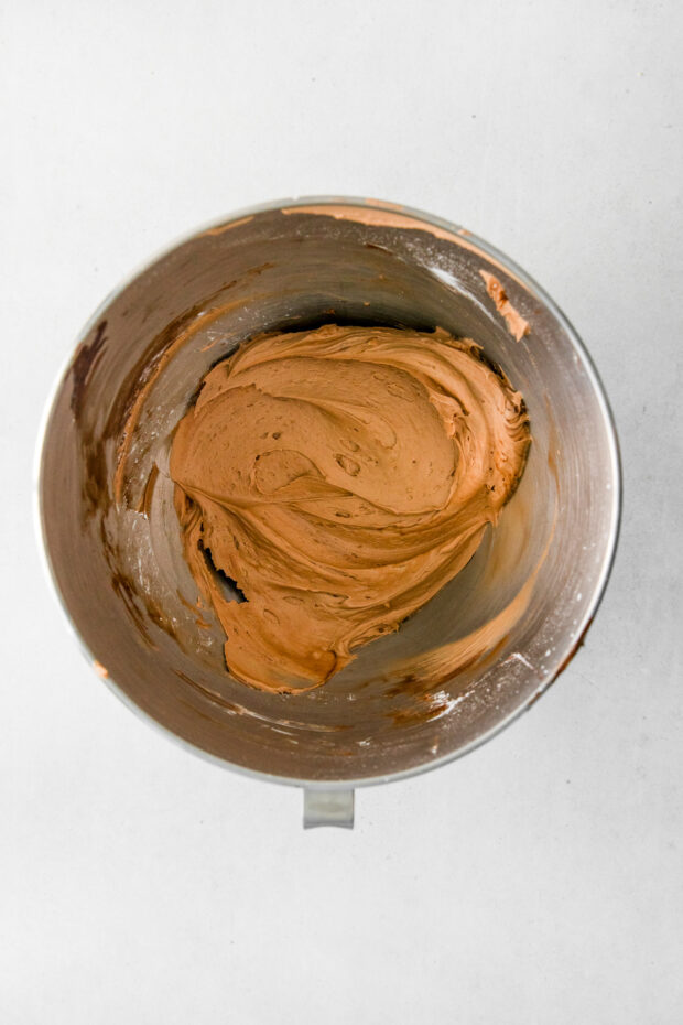 Chocolate frosting in a mixing bowl. 