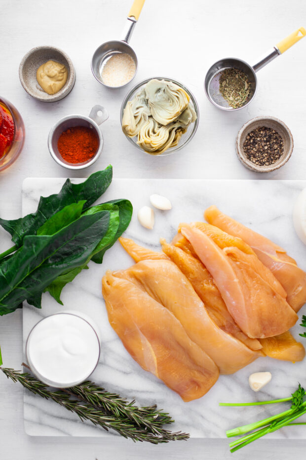 Ingredients to make Creamy Tuscan Chicken on a table. 