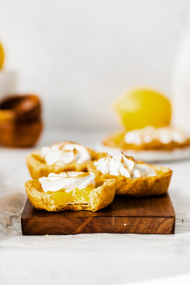 Mini Lemon Meringue Tarts with a bite taken out of them. 