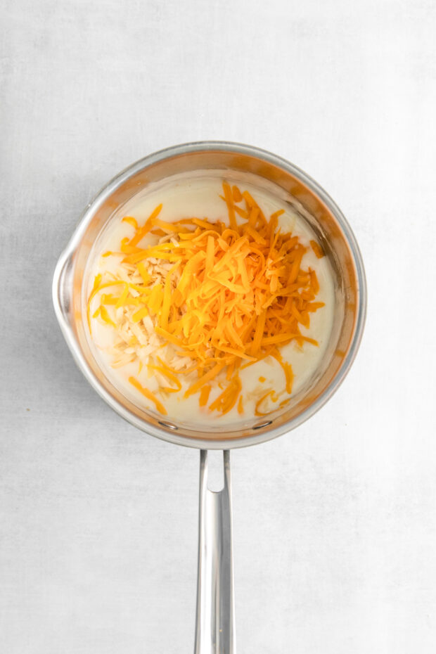 Cheese sauce being made in a skillet.