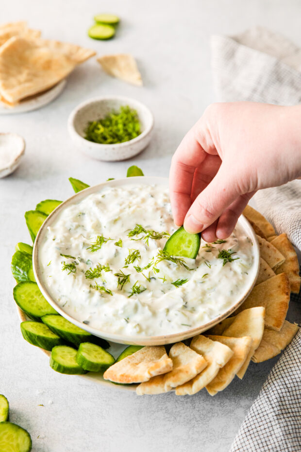 Tzatziki Sauce in a bowl with veggies on the side.