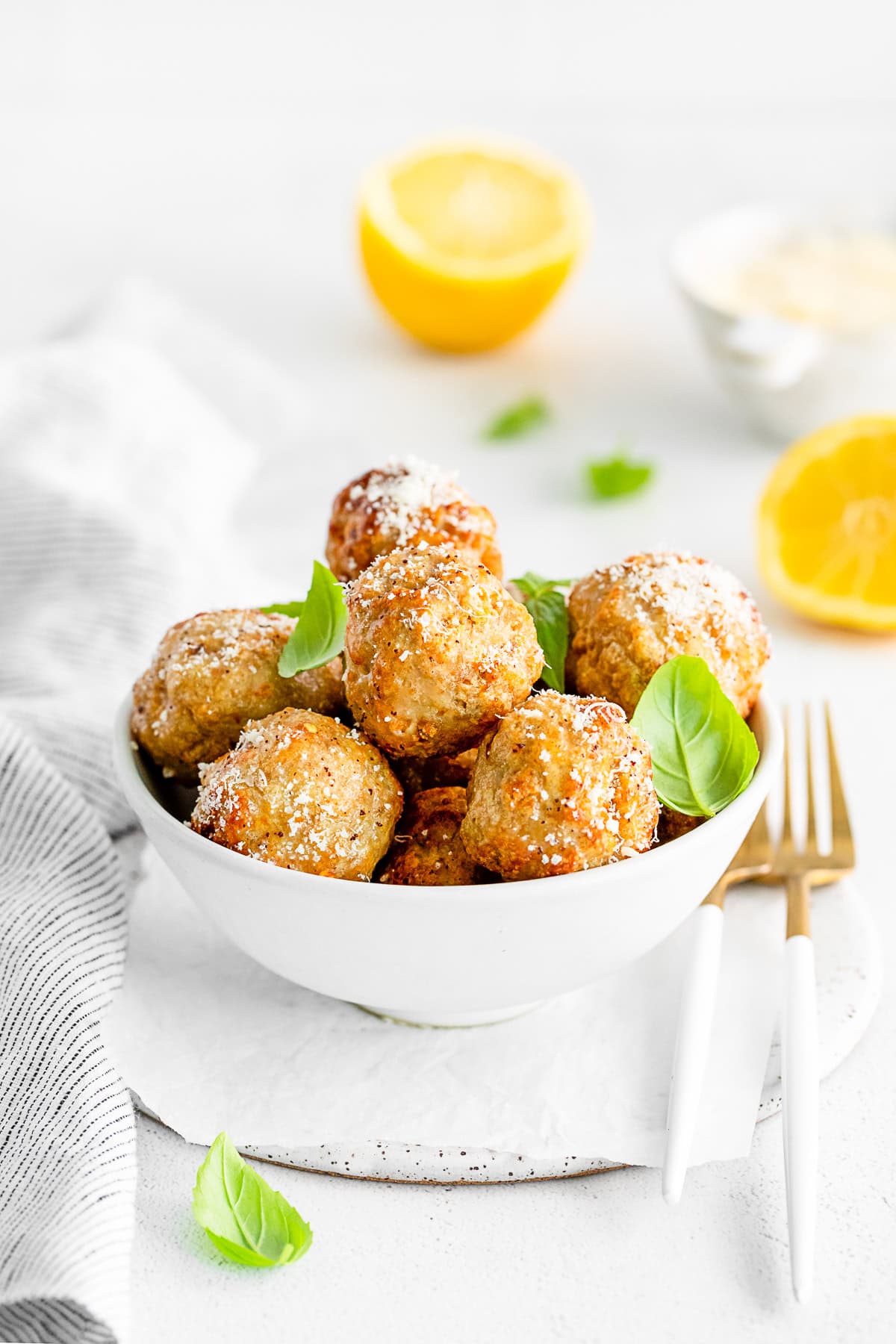 Air Fryer Chicken Meatballs sprinkled with parmesan cheese. 