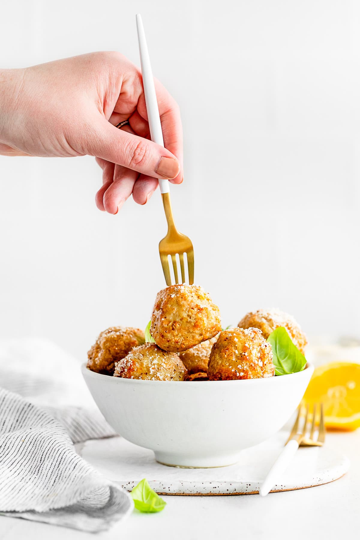 A fork picking up a Air Fryer Chicken Meatball. 