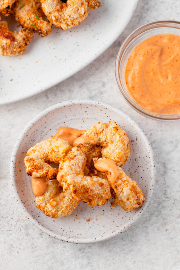 Crispy Air Fryer Shrimp drizzled with spicy mayo.