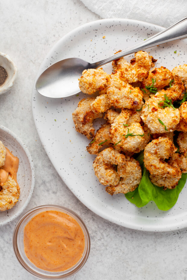 Crispy Air Fryer Shrimp ona. plate with dipping sauce.