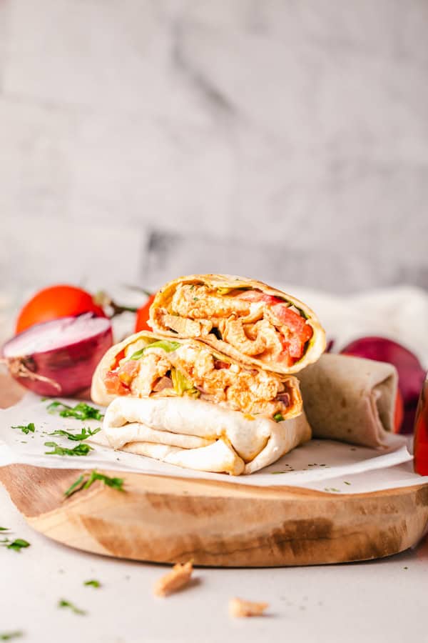 Buffalo Chicken Wrap cut in half on a serving board. 