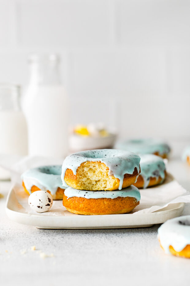 A baked donut with a bite taken out of it. 
