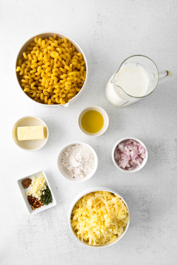 ingredients to make homemade mac and cheese on a table. 