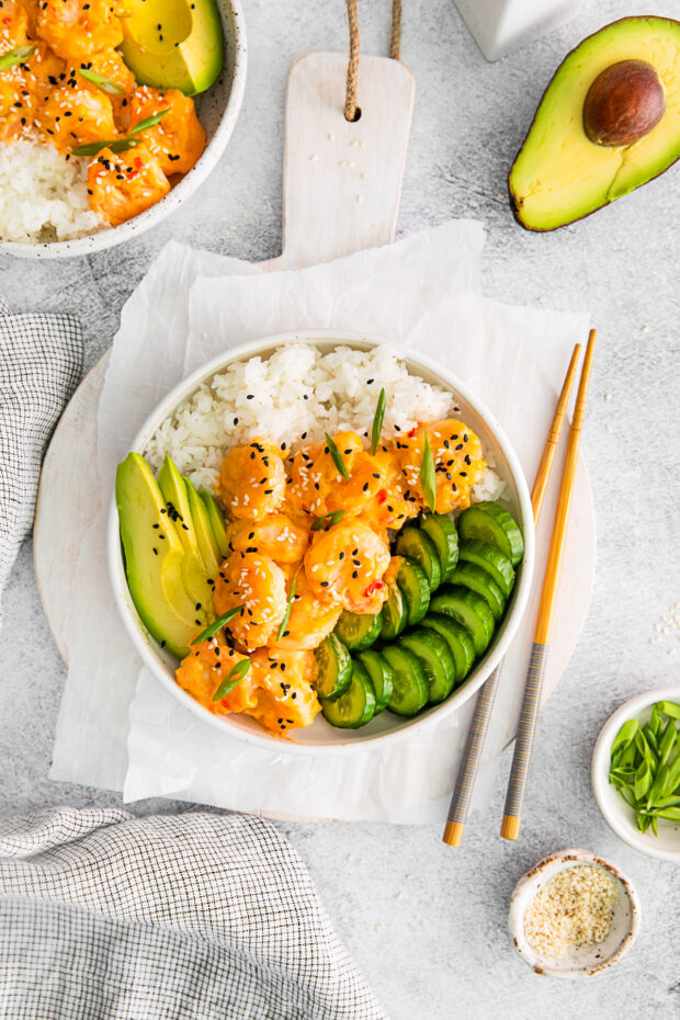 Bang Bang shrimp bowl in a white bowl with chop sticks.