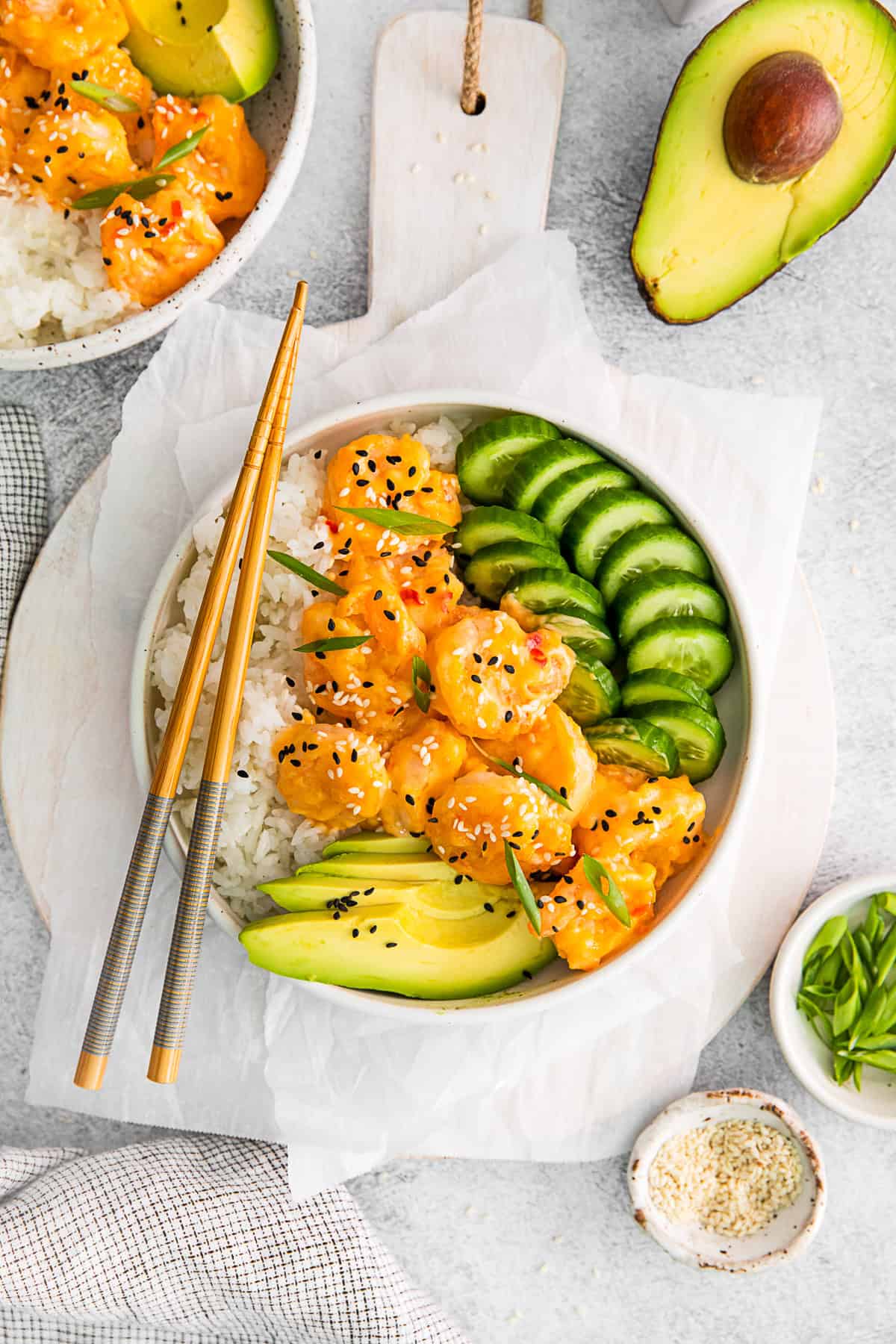 Chop sticks resting on a Bang Bang Shrimp Bowl.
