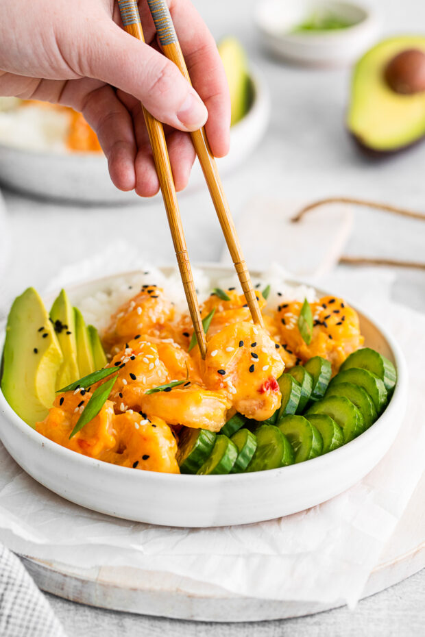 Chopsticks picking up a shrimp.