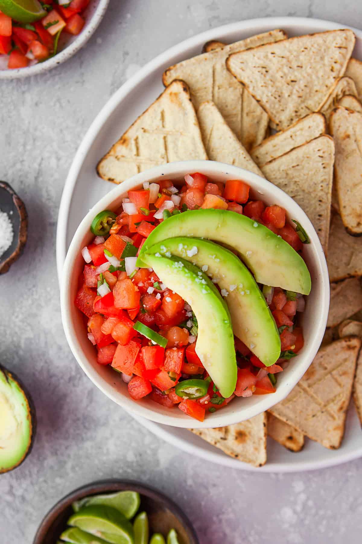 Pico de Gallo in a bowl topped with avocado. 