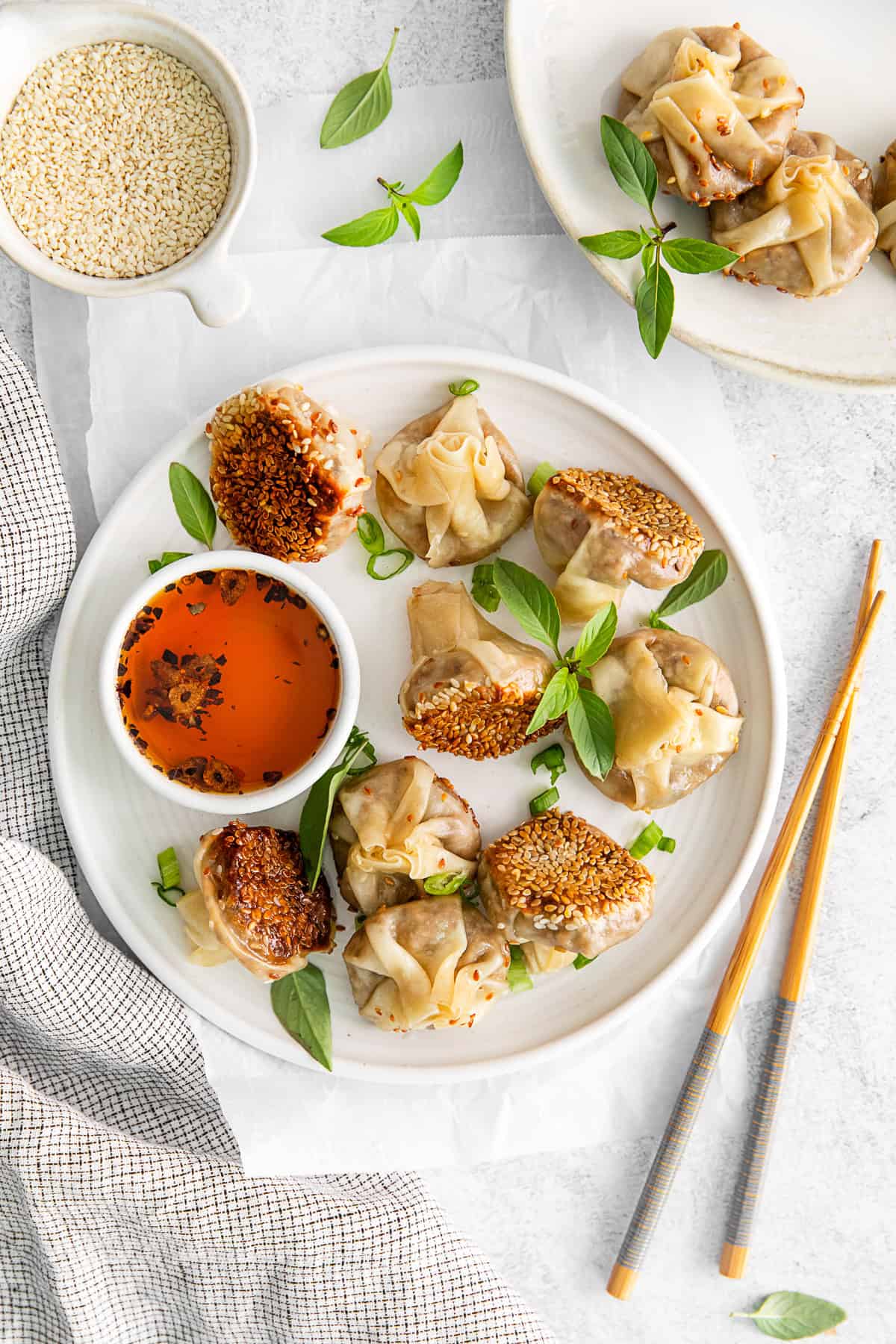 Shiitake Mushroom Dumplings on a plate with Thai basil. 